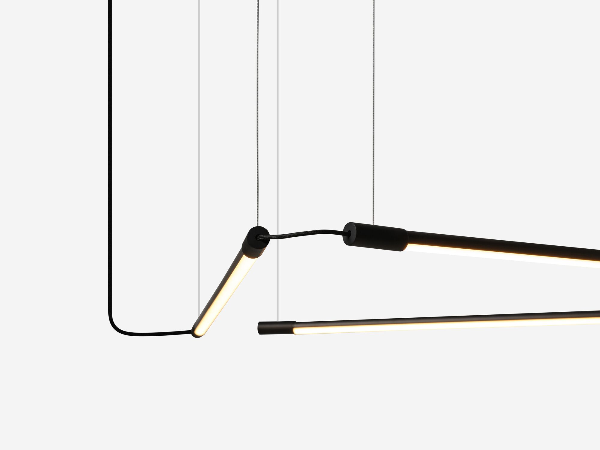 Detail view of curving slim black pendant lamp in triangular form
